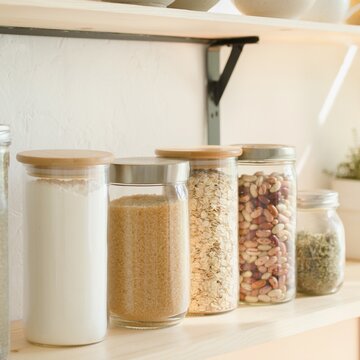 set of plain glass jars with homemade pantry staples