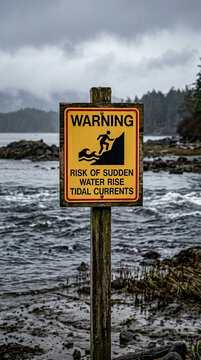 Warning Sign Risk of Sudden Water Rise and Tidal Currents Coastal Scene Overcast Sky