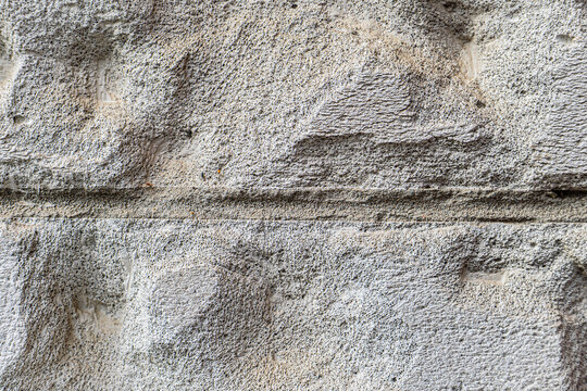 Macro Texture of Weathered Chiseled Stone Block Wall with Horizontal Mortar Joint and Rough Ashlar Relief