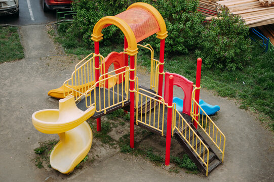 Colorful outdoor playground with slides and climbing equipment in residential area
