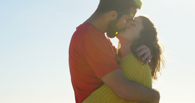 Young couple kissing and embracing on a sunny day