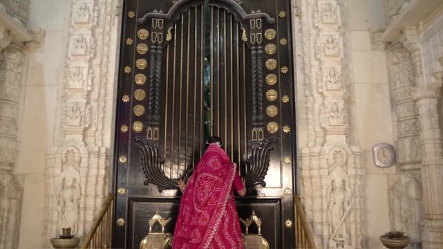 Opening the Ornate Inner Door of a Jain Temple to Reveal Sacred Idols of Shri Parshvanath Bhagwan and Other Jain Tirthankars During Religious Worship