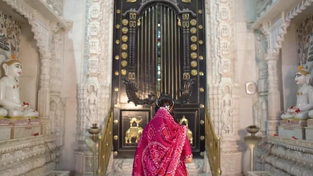 Opening the Ornate Inner Door of a Jain Temple to Reveal Sacred Idols of Shri Parshvanath Bhagwan and Other Jain Tirthankars During Religious Worship