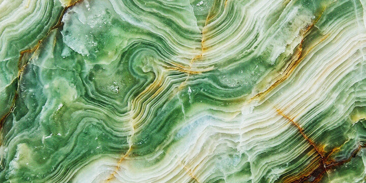 Green onyx stone texture with natural wavy patterns and golden veins showing polished mineral surface details for luxury interior architecture backgrounds or elegant decorative wall cladding material
