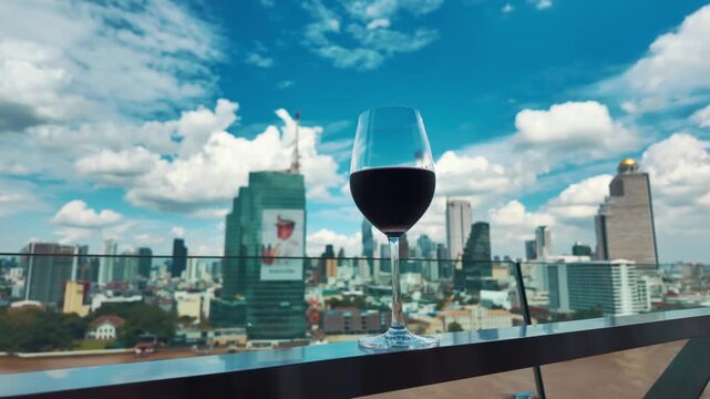 red wine on terrace with Bangkok city skyline at sunset, cocktail on rooftop, vibrant cityscape and luxury panorama view 4k