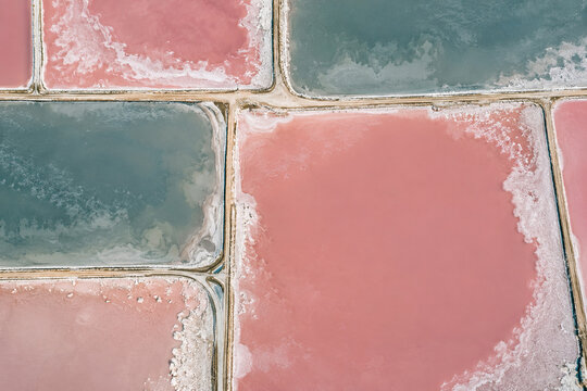 Pink and teal salt evaporation ponds viewed from above