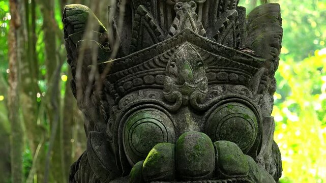Close up of carved Barong guardian statue against sunlit jungle Bali