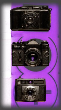 sequence of different vintage analogue film cameras vertical