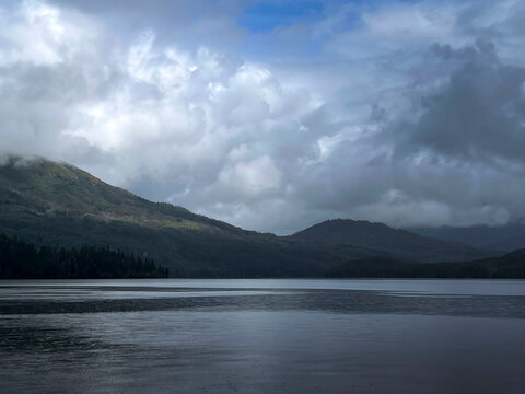 Mountains around a lake near Soldatna, Alaska on a cloudy summer day.