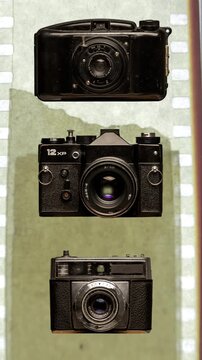 sequence of different vintage analogue film cameras vertical