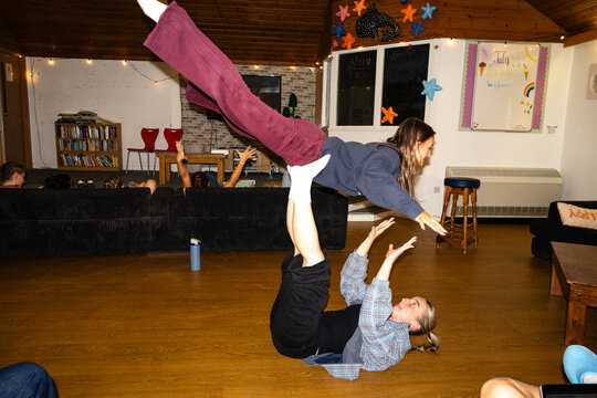 Candid acrobatic lift captured in a student common room