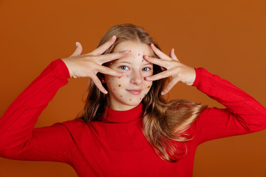 Girl playing with face stickers