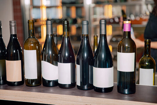 Assorted Wine Bottle Collection with Blank Labels on a Retail Display