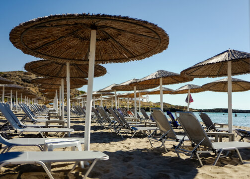 Lines of loungers and parasols on a tourist beach in Europe