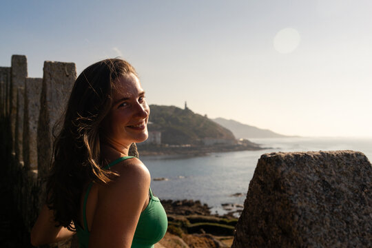 A warm smile above Baiona's rugged coastline