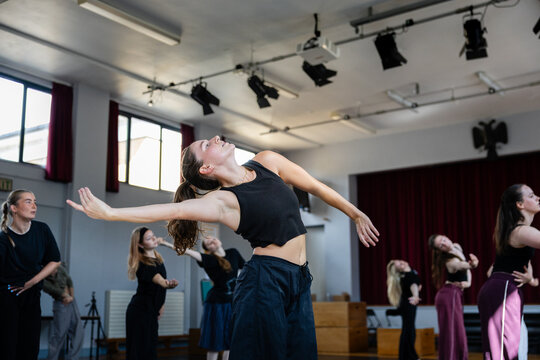 Dancer arching back with arms outstretched