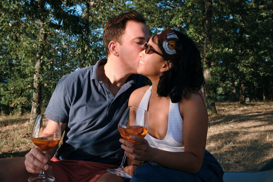 Couple Kissing with Drinks in Italian Forest