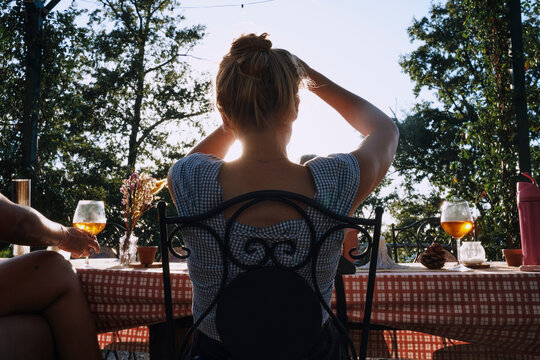 Woman at Outdoor Table at Golden Hour in Italy
