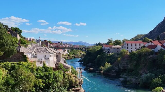 Scenic aerial drone footage of the historic Stari Most Old Bridge spanning the Neretva River in the city of Mostar, Bosnia and Herzegovina
