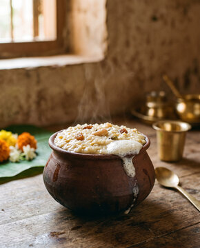 Pongal rice cooking in a rustic clay pot