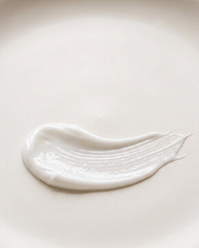 White cosmetic cream smear on a neutral surface