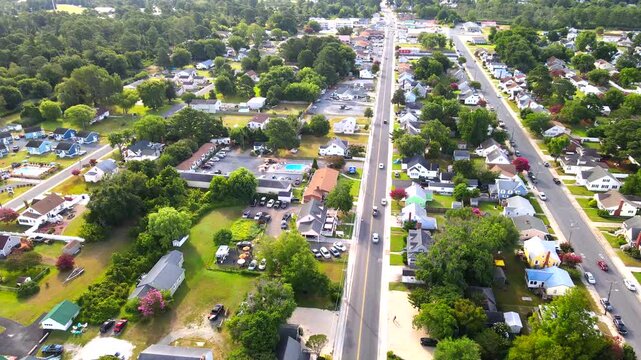 Roadside accommodation and a swimming pool appear beside a Chincoteague residential street.