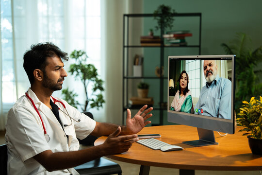 Young Indian Male Doctor Providing Telemedicine Consultation from Clinic