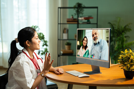 Young Indian Female Doctor Providing Online Consultation from Cozy Clinic