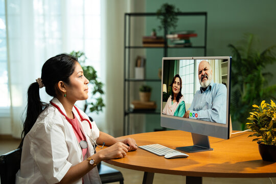 Young Indian Female Doctor Providing Online Consultation from Cozy Clinic