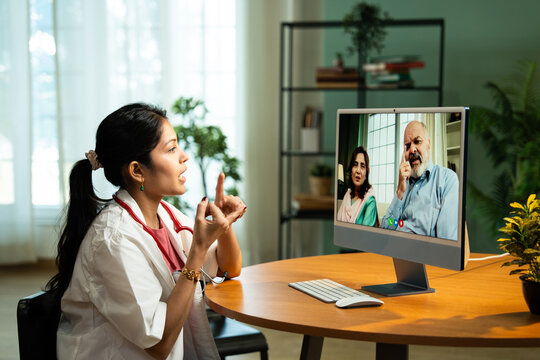 Young Indian Female Doctor Providing Online Consultation from Cozy Clinic