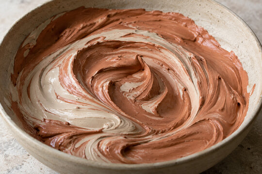 Natural clay slip swirling inside a potters mixing bowl