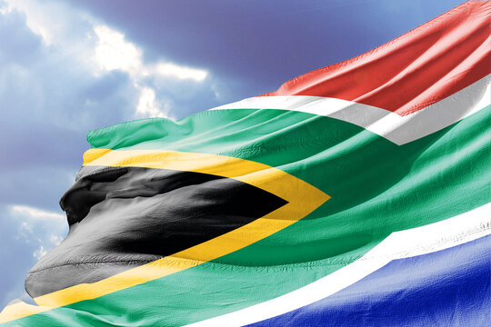 South African Flag Waving in the Wind against a Cloudy Sky