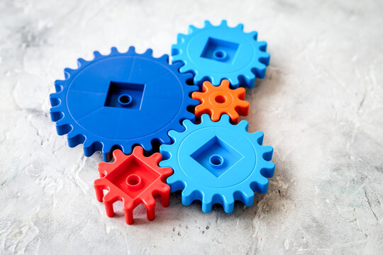 moving forward concept, ideal operating principle with gears and wheels on stone background