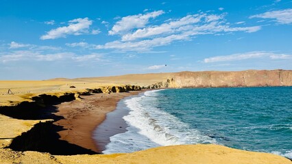 A striking red-sand coastline in Paracas National Reserve in Peru © Danhua