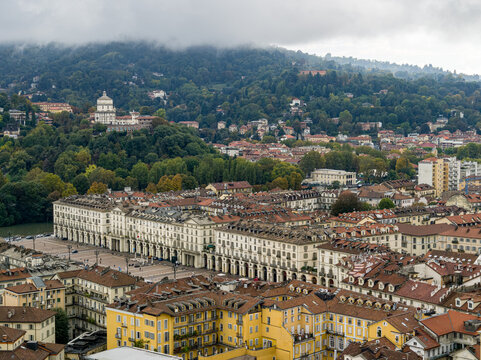 Turin's historic center, featuring Piazza Vittorio Veneto beneath wooded Superga hills