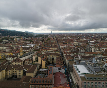 Turin, Italy, stretching across the horizon beneath heavy clouds over historic rooftops