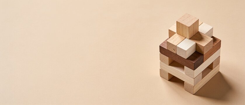 Minimalist wooden block pyramid structure on neutral background