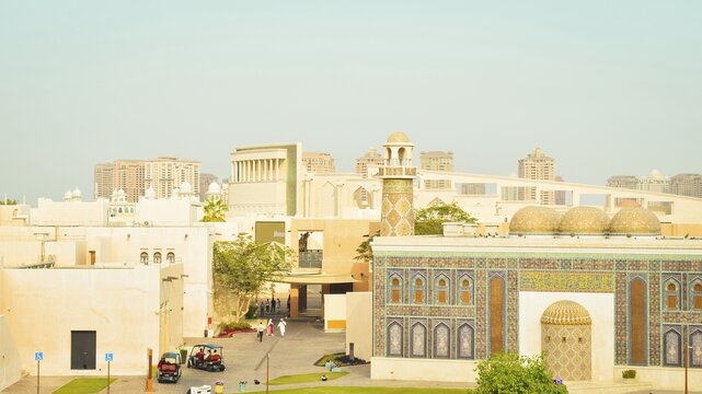Doha, Qatar - january 7th, 2026: historical Katara Cultural Village in Doha, Qatar. People enjoy the promenade by the iconic Pigeon Towers and Blue Mosque, blending heritage with modern city views