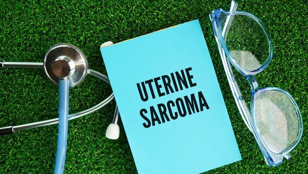 Stethoscope, glasses and paper tag with the words Uterine sarcoma is a rare and aggressive type of cancer that develops in the muscles or connective tissues of the uterus womb