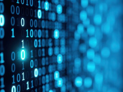 Binary code overlay on futuristic digital background with glowing pixels