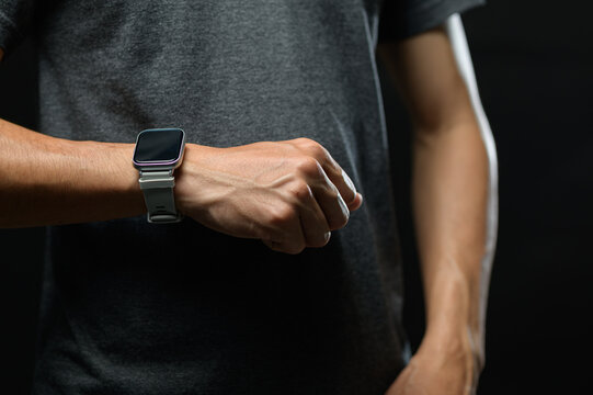 Close-up of a person wearing a smartwatch on wrist in casual clothing