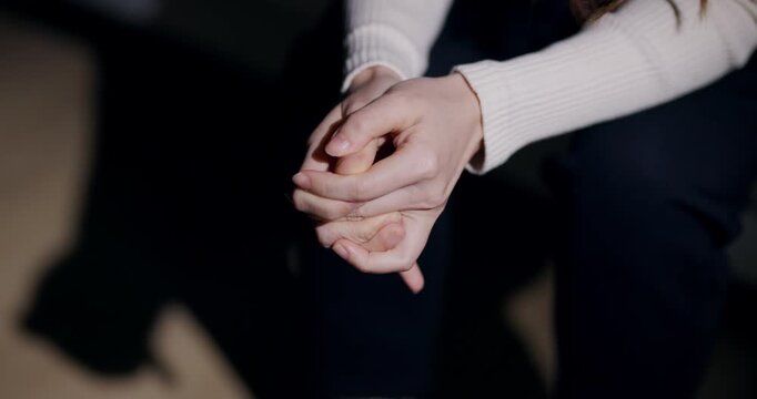 Close-up of hands wringing and clasping fingers showing anxiety and nervous stress