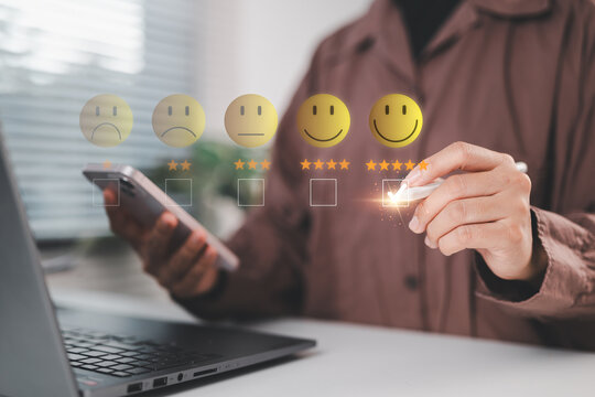 Customer satisfaction survey concept, Woman using laptop, touching smiling happy icon, satisfied five stars, customer evaluate the quality of service which leads to business reputation ranking.