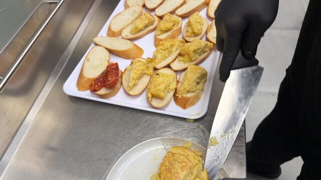 Chef preparing spanish omelette pinchos in madrid