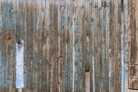 Weathered Wooden Surface with Peeling Paint and Metal Strips