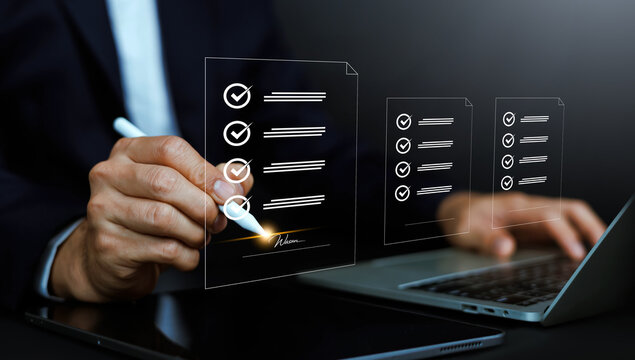 Business person using a stylus pen to digitally sign a contract document with checkmarks. Concept of electronic signature, e-contract, agreement approval, and paperless workflow.