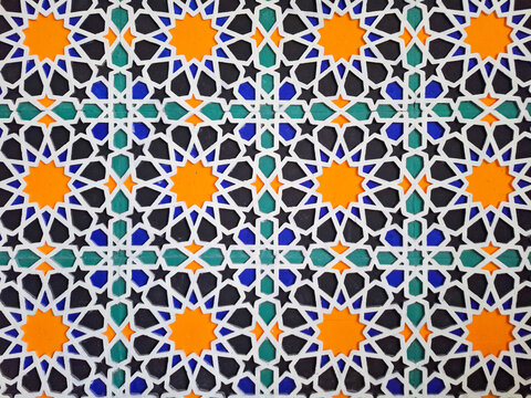 Commercial photo of traditional Islamic geometric pattern wall decoration with colorful star tiles