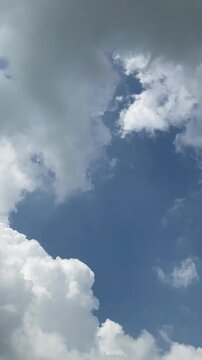 Dark storm clouds gathering in a blue sky vertical video