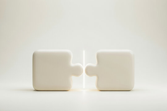 Two large puzzle pieces about to interlock