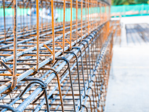 Close up industry steel reinforcement rod in building factory. Wire cable metal and deformed bar with rebar at construction site industrial plant. Infrastructure of building.